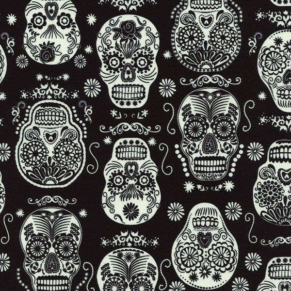 Glow in the Dark Folklore Skulls on Black by Timeless Treasures
