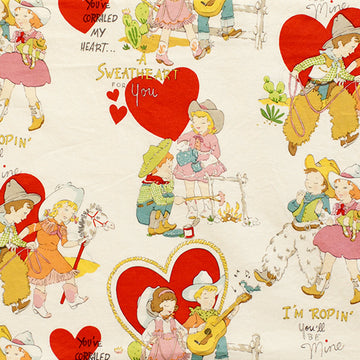 I'm Roping You'll Be Mine in Tea Dye by Alexander Henry Fabrics, vintage valentine print with cowboy and cowgirl sweethearts, red hearts, lassos, prickly pear and a stick horse on a tea-dyed cream ground