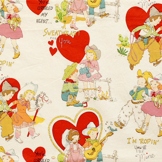 I'm Roping You'll Be Mine in Tea Dye by Alexander Henry Fabrics, vintage valentine print with cowboy and cowgirl sweethearts, red hearts, lassos, prickly pear and a stick horse on a tea-dyed cream ground