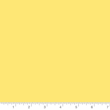 Colorworks Solid Lemon by Northcott, solid quilting cotton with a ruler for scale