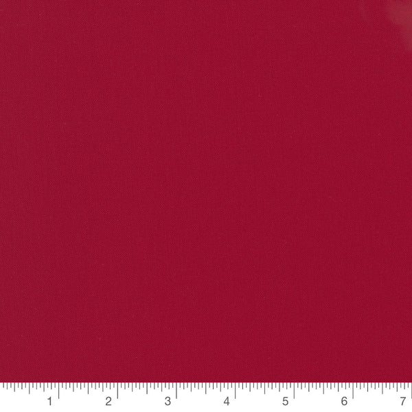 Christmas Red Bella Solid by Moda Fabrics, solid red quilting cotton fabric swatch with inch ruler for scale
