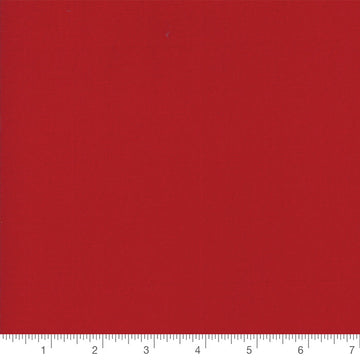 Country Red Bella Solid by Moda, solid quilting cotton with a ruler for scale