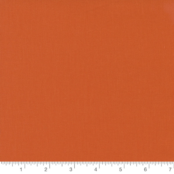 Clementine Orange Bella Solid by Moda Fabrics, solid orange quilting cotton fabric swatch with inch ruler for scale