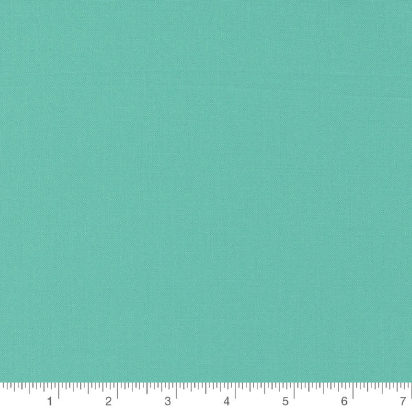 Peacock Turquoise Bella Solid by Moda Fabrics, solid turquoise quilting cotton fabric swatch with inch ruler for scale