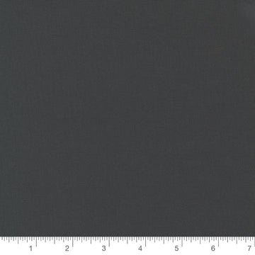 Bella Solids in Charcoal by Moda, dark charcoal grey solid quilting cotton with a ruler for scale