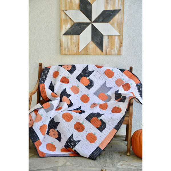 Pumpkins and Cats quilt draped over a chair P156-PUMPKINSCATS