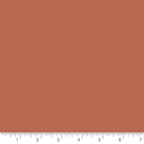 Pure Solids in Terracotta Tile by Art Gallery Fabrics, solid quilting cotton with a ruler for scale