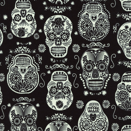 Glow in the Dark Folklore Skulls on Black by Timeless Treasures