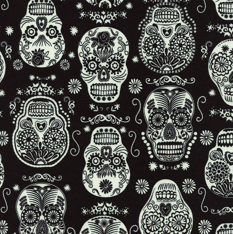 Glow in the Dark Folklore Skulls on Black by Timeless Treasures